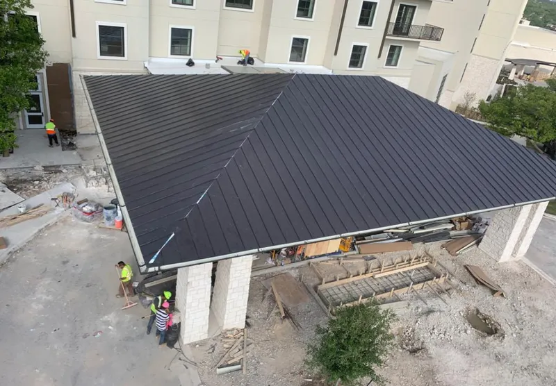 Metal roofing installation team working on a commercial building in Nanakuli